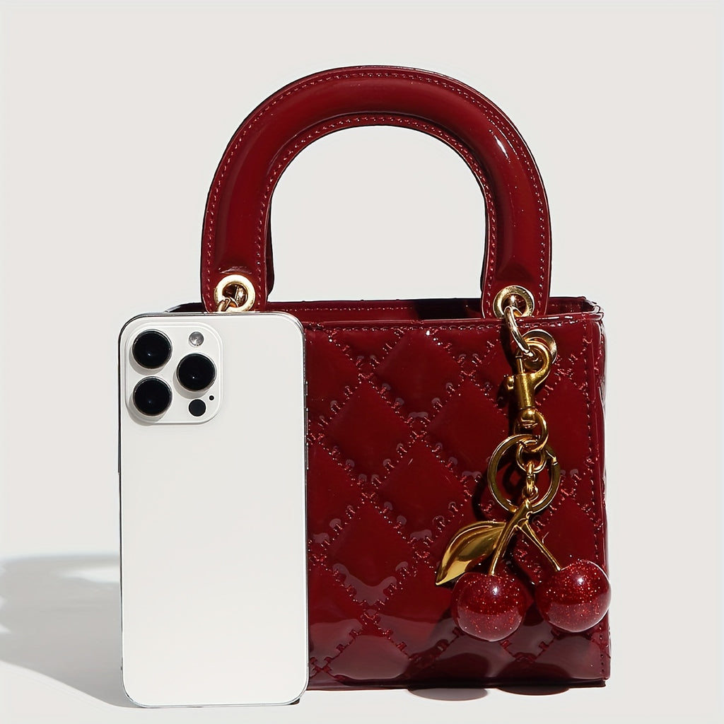 Sac à main rouge élégant avec quincaillerie dorée, fermeture magnétique et motif détaillé